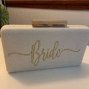 Tan clutch with ‘bride’ embroidered in gold